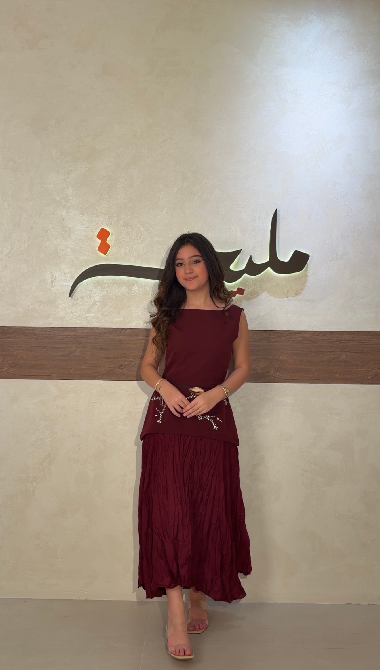 The burgundy dress with pearl embroidery and a gold belt is back in stock.  -