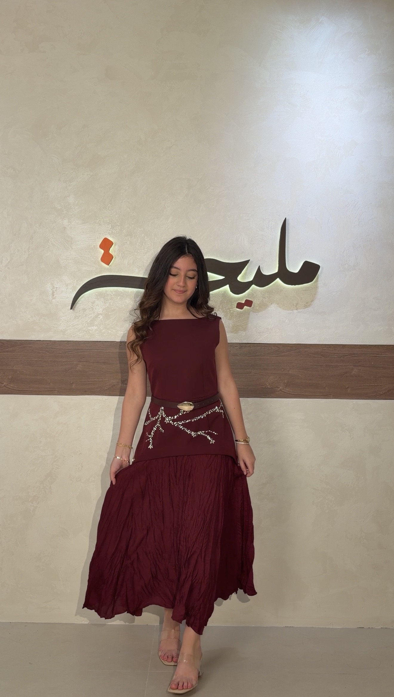 The burgundy dress with pearl embroidery and a gold belt is back in stock.  -
