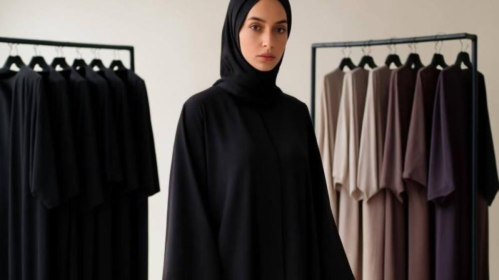 امرأة ترتدي عباية سوداء في مشهد تحريري يوضح تنوع تصاميم العبايات
