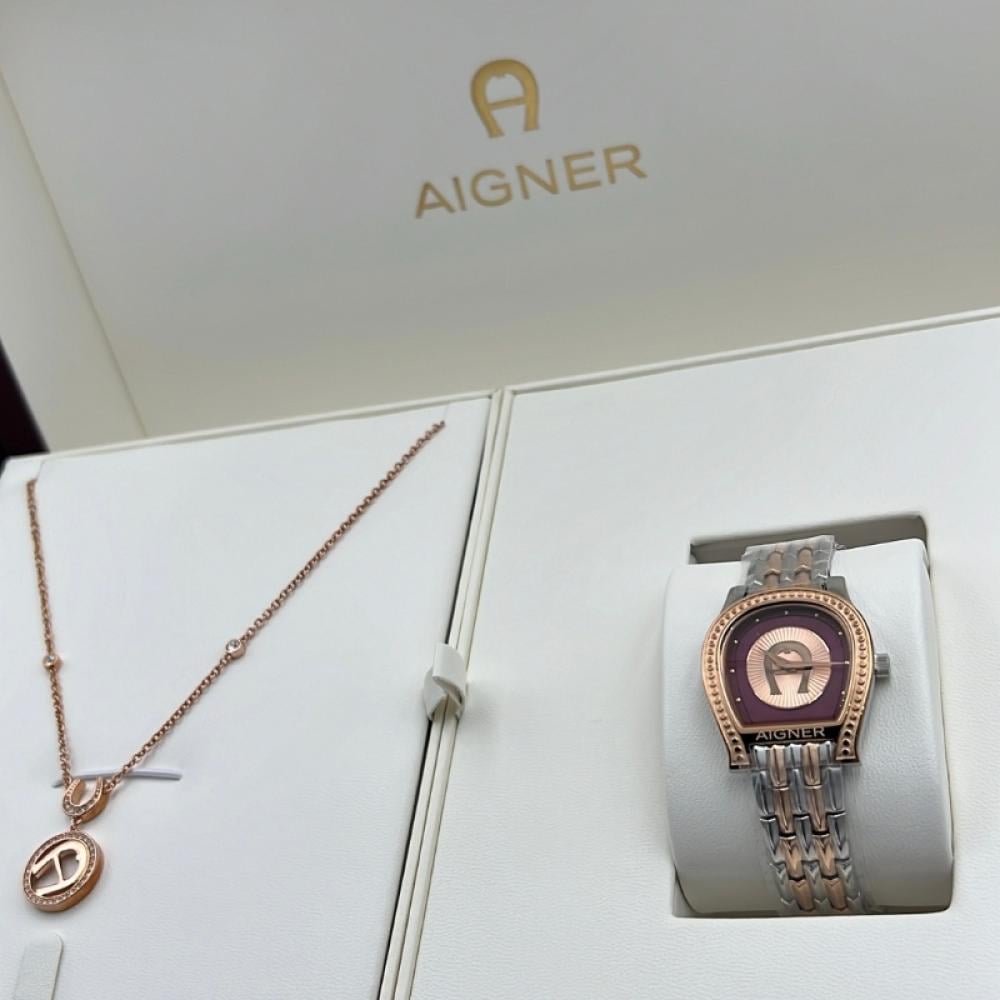 طقم ساعة وسلسالAigner بلون ذهبي وردي تصميم فاخر وأناقة متكاملة