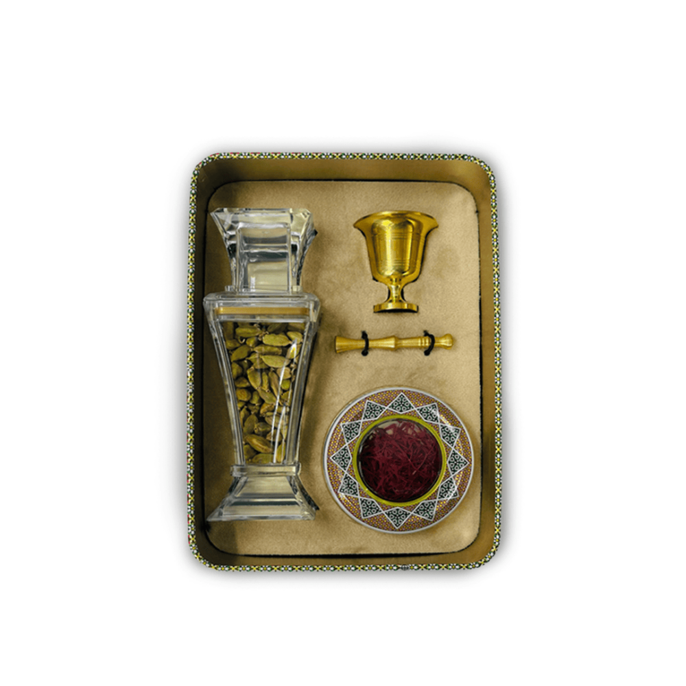 Open Hayala gift box showing cardamom in a glass bottle, saffron in a decorated tin and the golden najr