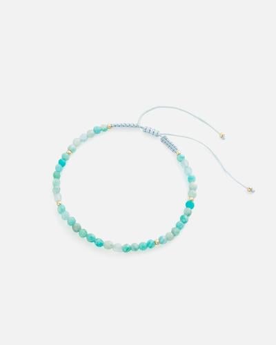 Women's bracelet with woven threads and blue beads