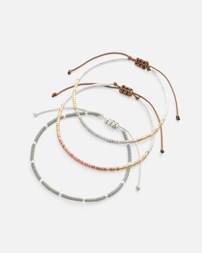 Bracelets made of threads and beads in gold, silver, and gray