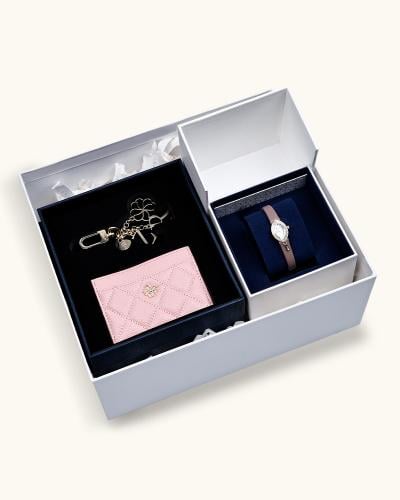 A women's gift set including a watch, wallet, and keychain