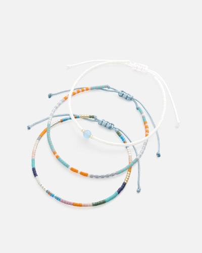 Bracelets made of threads and beads in white, blue, and orange