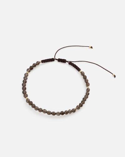 Women's bracelet with woven threads and brown beads