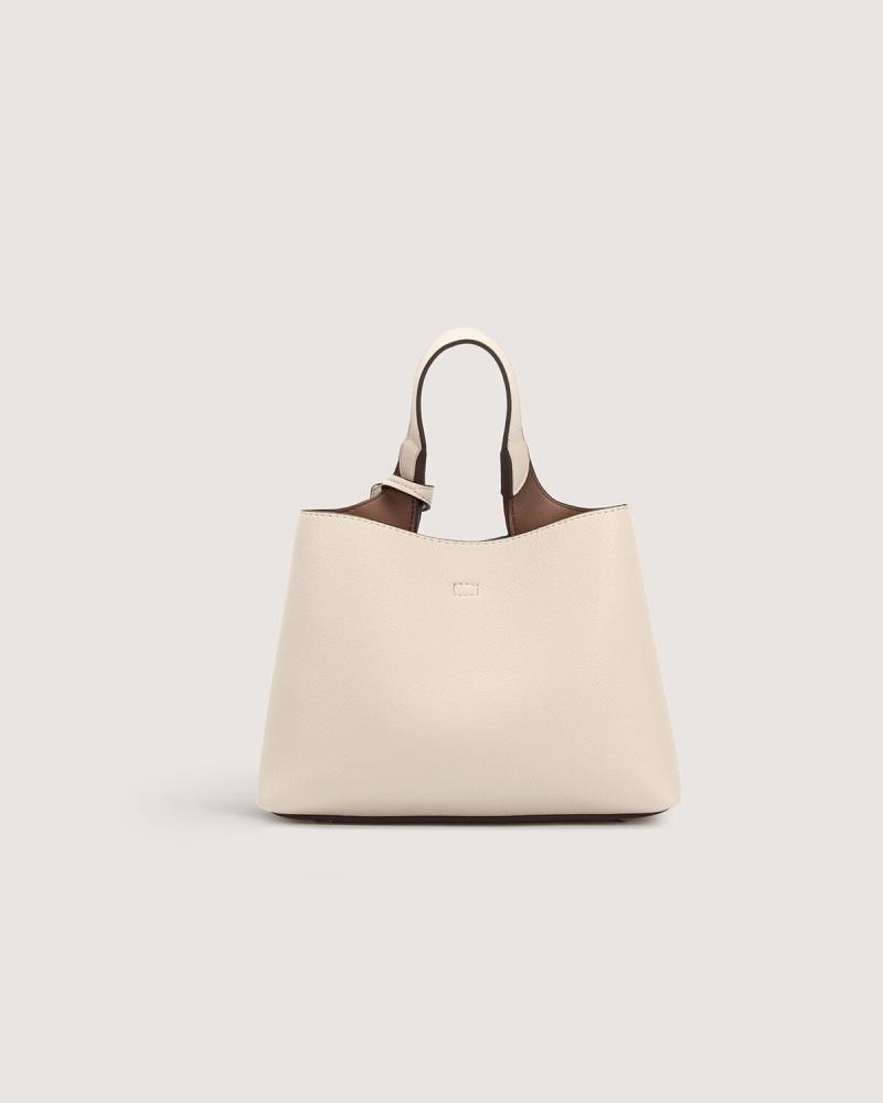 Women's handbag with a practical design in beige color
