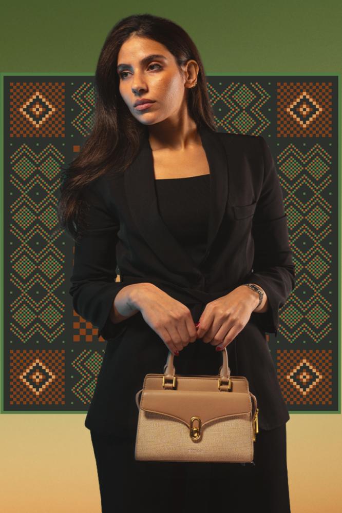 Women's beige leather handbag with a classic design