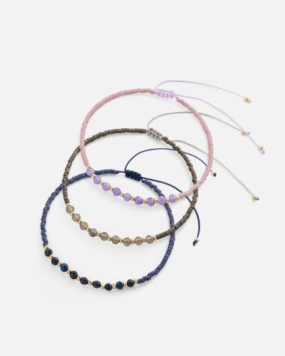 Bracelets made of threads and beads in pink, blue, and gray