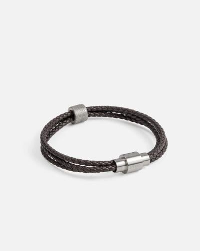 Three connected bracelets made of brown braided leather