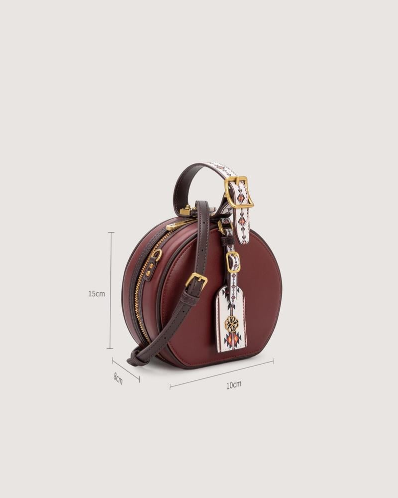 Women's mini round bag in burgundy color