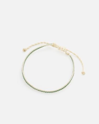 A bracelet made of beige threads and green beads