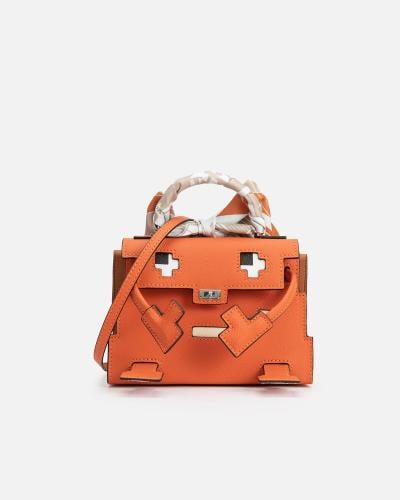 A distinctive women's handbag made of leather in an orange color.