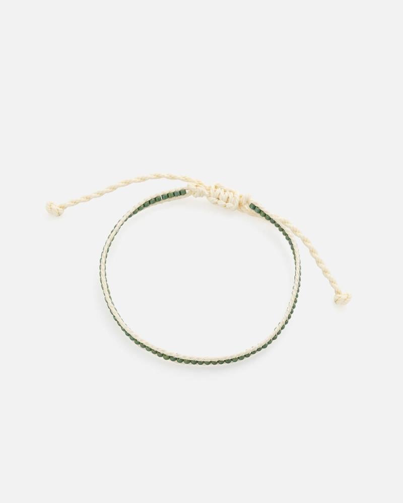 A bracelet made of beige threads and green beads