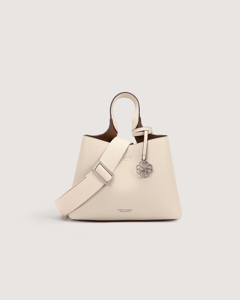 Women's handbag with a practical design in beige color