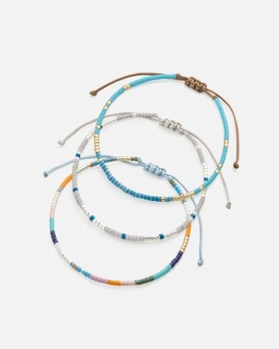 Bracelets made of threads and beads in a harmonious range of colors