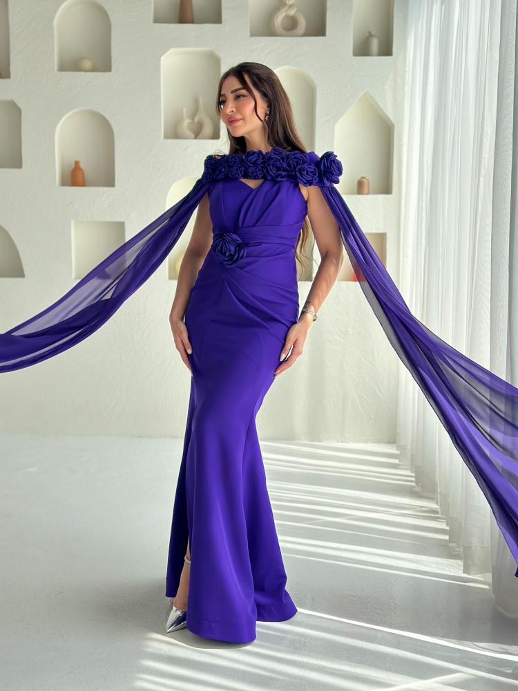 Purple taffeta evening dress with long wide sleeves and decorated with three dimensional flowers at the waist and shoulders