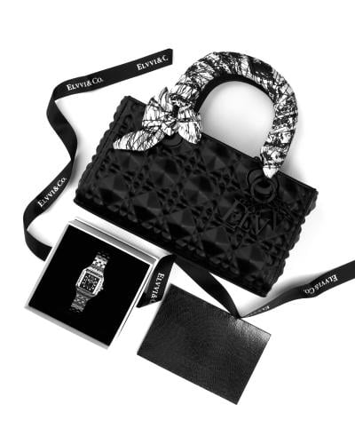 A stylish women's handbag with a watch to complete your look