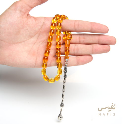 سبحة كهرمان شفاف اصفر محشرة