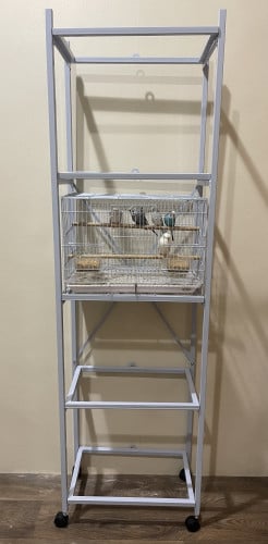 استاند قفص 600 متحرك و يحمل خمسة اقفاص و فيه مثبت علامة X