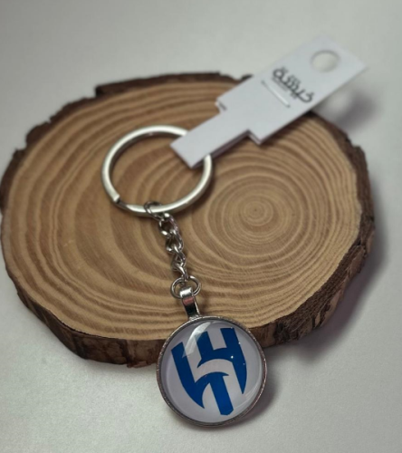 ميدالية مفاتيح دائرية الشكل من الزجاج بشعار نادي الهلال السعودي وتعليقة على شكل قلب