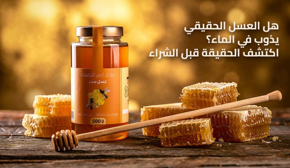 عسل طبيعي حقيقي داخل ملعقة زجاجية فوق كوب ماء