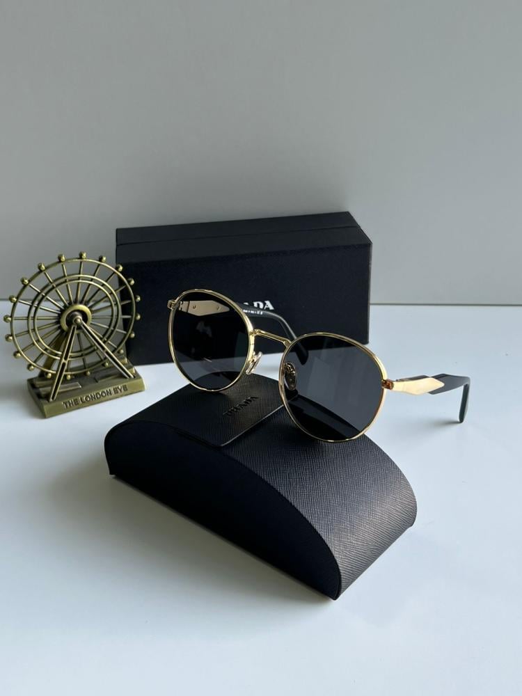 Prada sunglasses, black round frame with gold rims