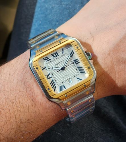 Santos de Cartier men's luxury watch in silver with a gold bezel