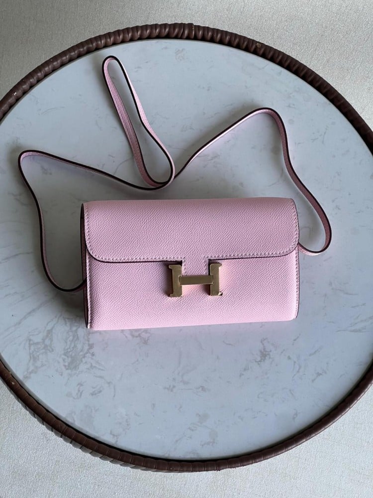 Elegant Hermes Constance shoulder bag in light pink with a