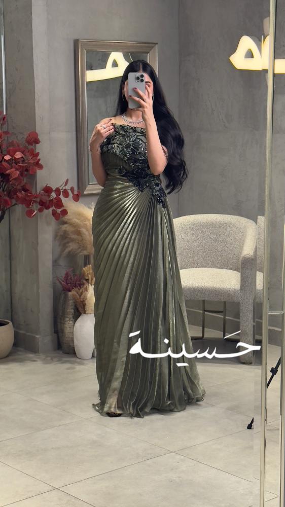 Olive green pleated dress with black embroidery and off-the