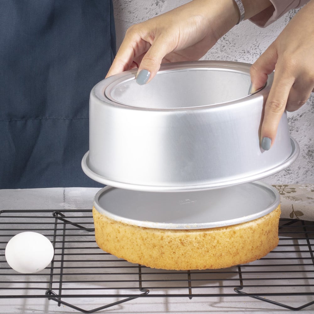 A silver circular cake and dessert tray