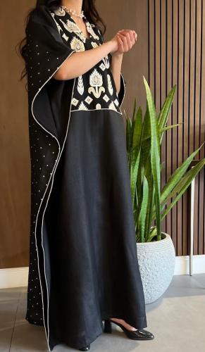 Ladies kaftan with embroidery and sequins behind lenin
