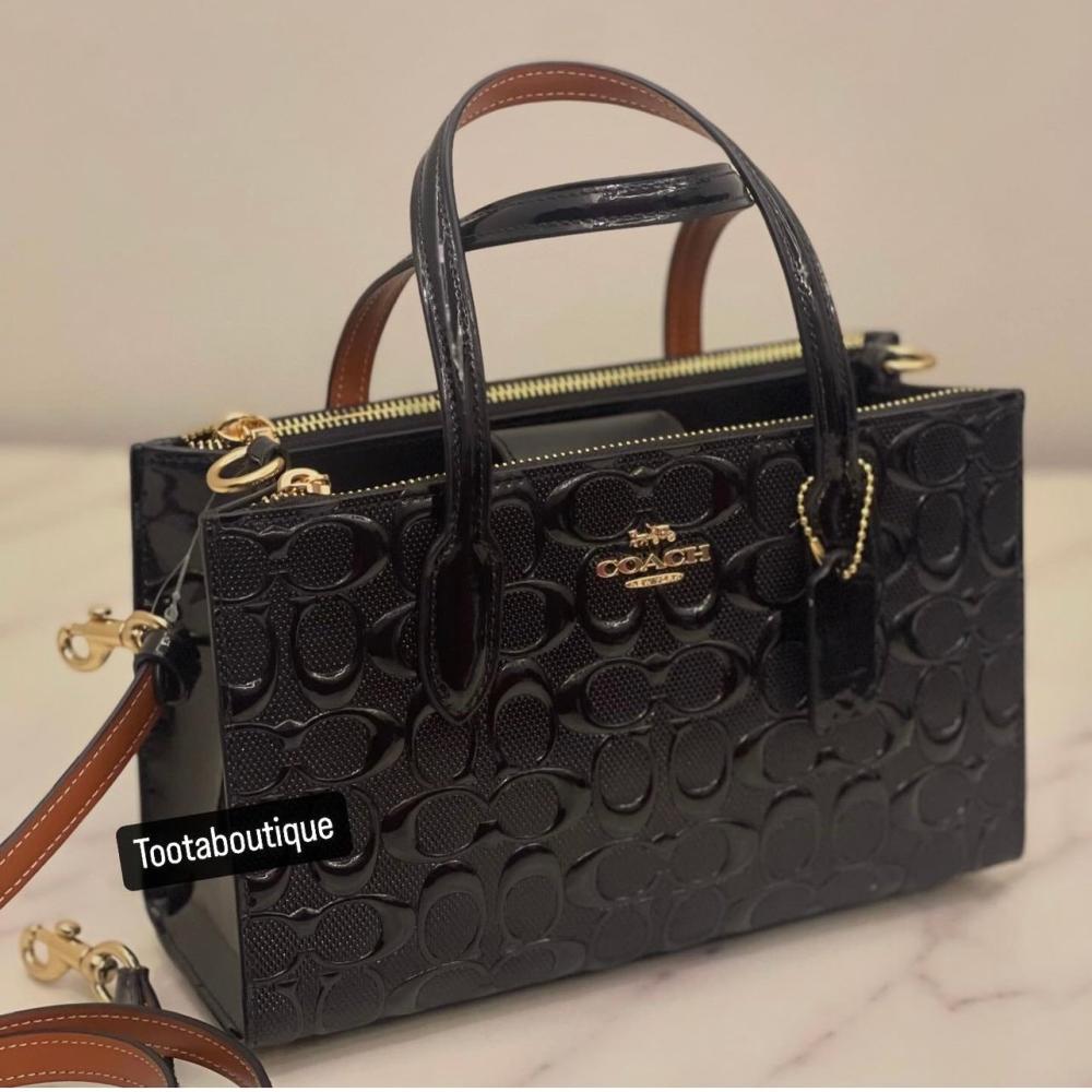 حقيبة كوتش نينا اسود لماع فوري