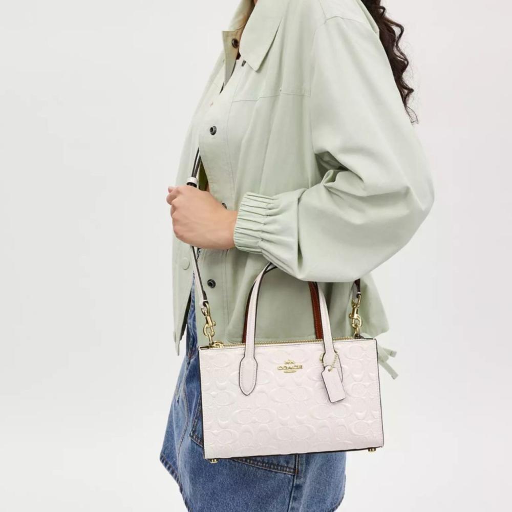 حقيبة كوتش نينا اسود لماع فوري