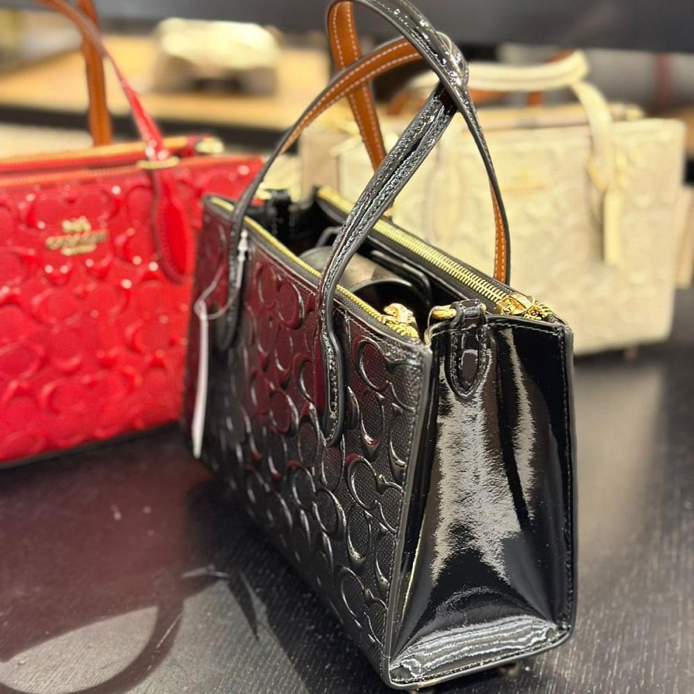 حقيبة كوتش نينا اسود لماع فوري