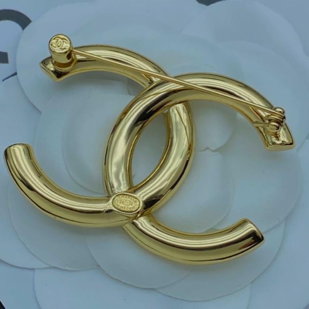 Gold purchases Chanel brooch