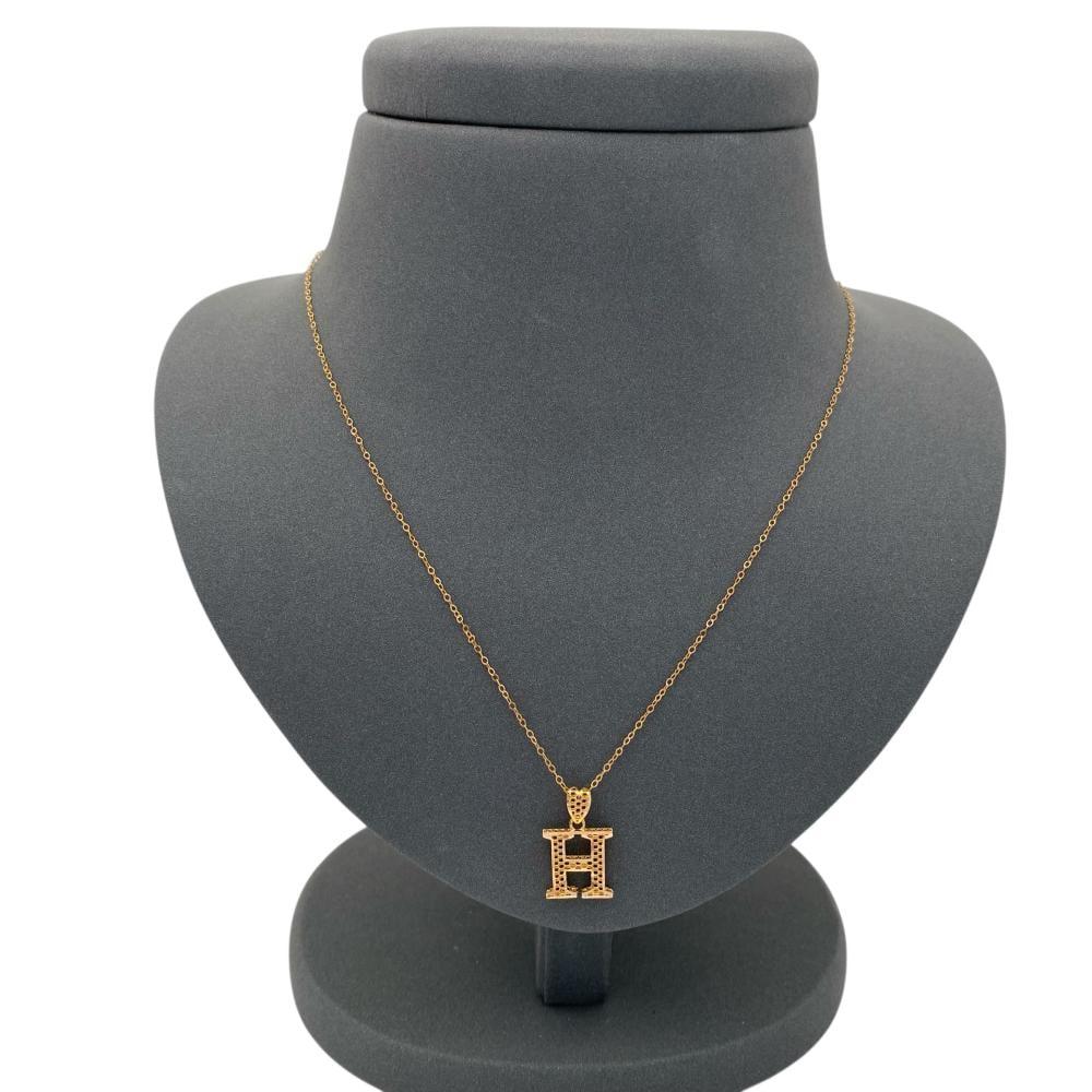 A 21-karat gold necklace with the letter H, weighing 1.54 grams