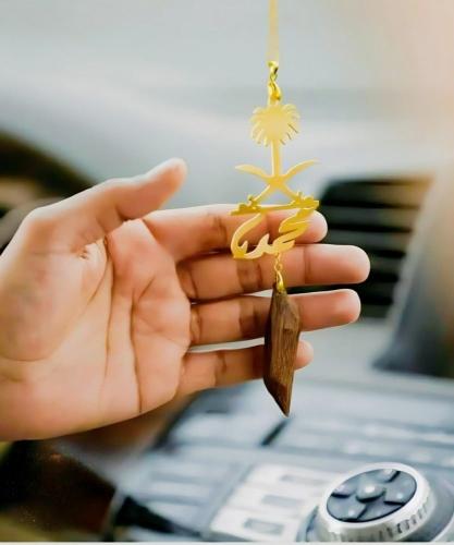 تعليقة سيارات بالاسم اللي تبي منحوت عليها السيفين والنخله مع كسرة العود الملكي