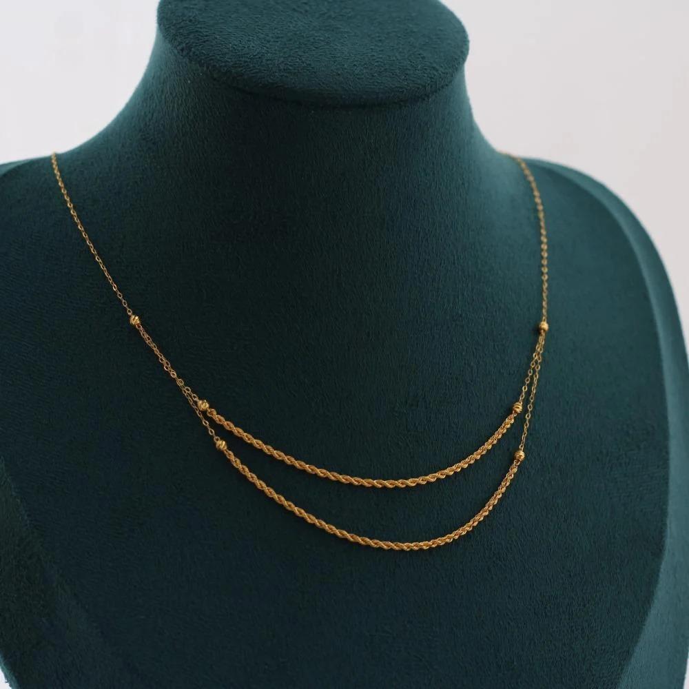 Two-tiered twisted necklace with 21-karat balls