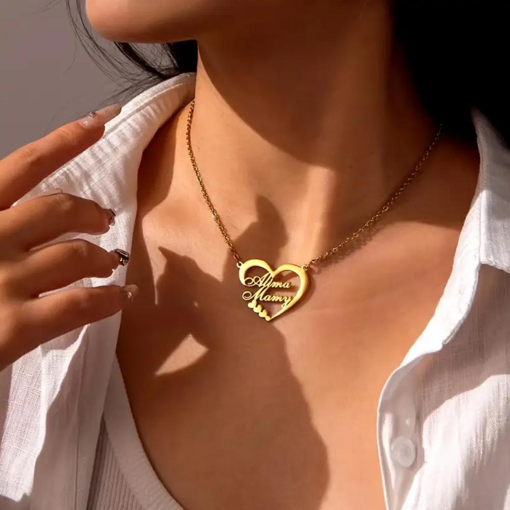 Gold necklace with two names in the shape of a heart الموقع