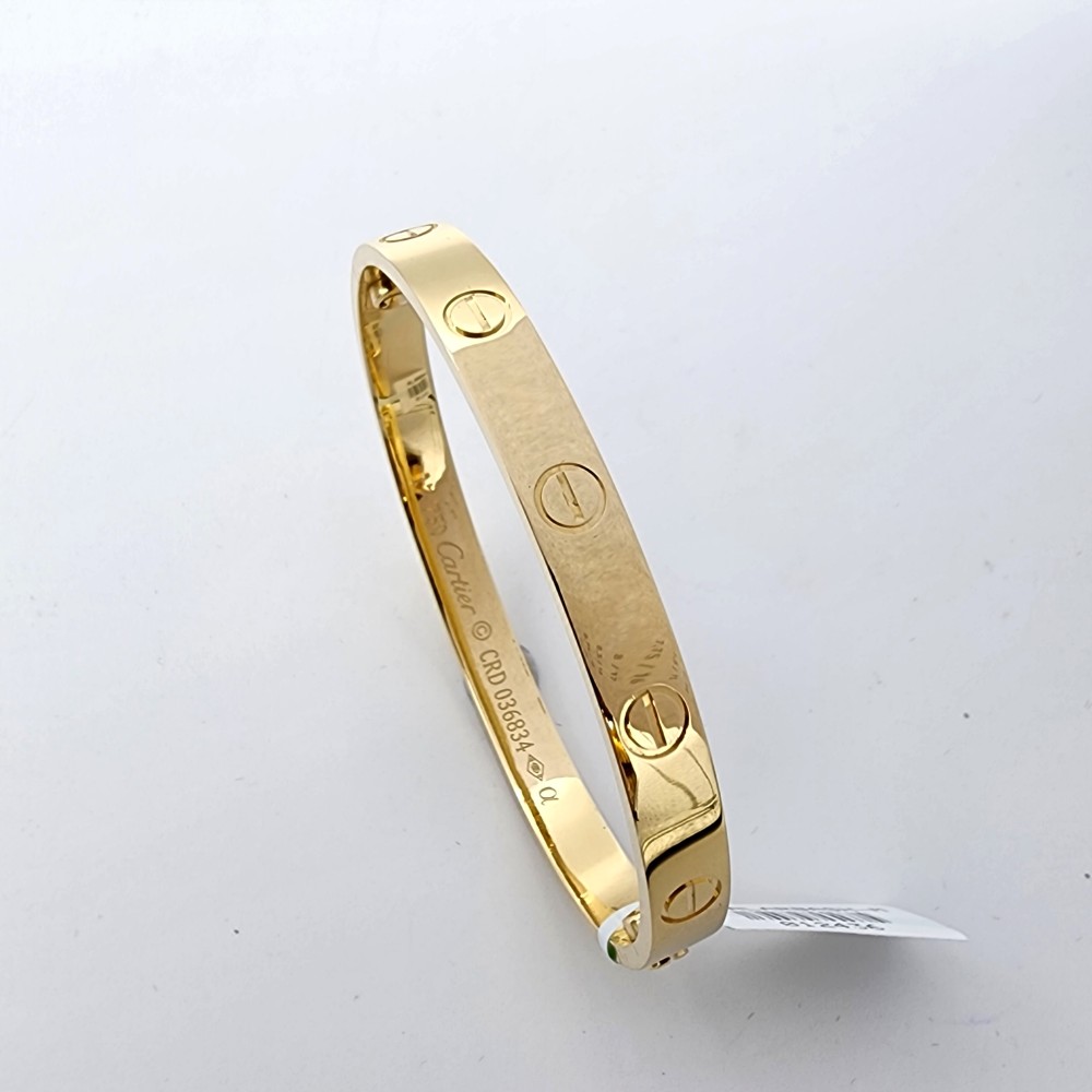 Bracelet with 1 charm and bangle, 18K gold, weight 11,2 grams. - Bukowskis