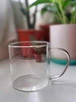 A transparent cup with a transparent handle