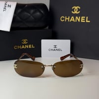 نظارة شانيل بدون إطار باللون الذهبي وعدسة بني