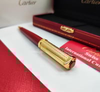 قلم وكبك سانتوس كارتير احمر ذهبي