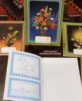 دفاتر مدرسية قديمة، يحتوي غلافها الداخلي على شهادة...