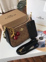 حقيبة كوتش تيري كلاسيكي بني