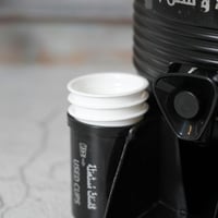 موزع مشروبات بعبارة ( أهلاً و سهلاً ) باللون الأسو...