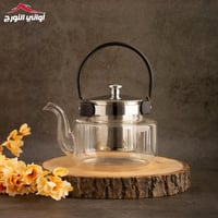 أبريق زجاجي شفاف بمسكة سوداء