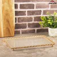 تبسي نسرين زجاج بإيطار ذهبي