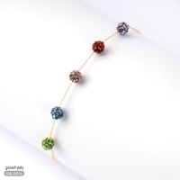 أسوارة ذهب عيار 18 بألوان كريستالية وأناقة ناعمة (...